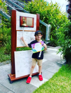 Chase ringing the bell to signal an end to his treatment